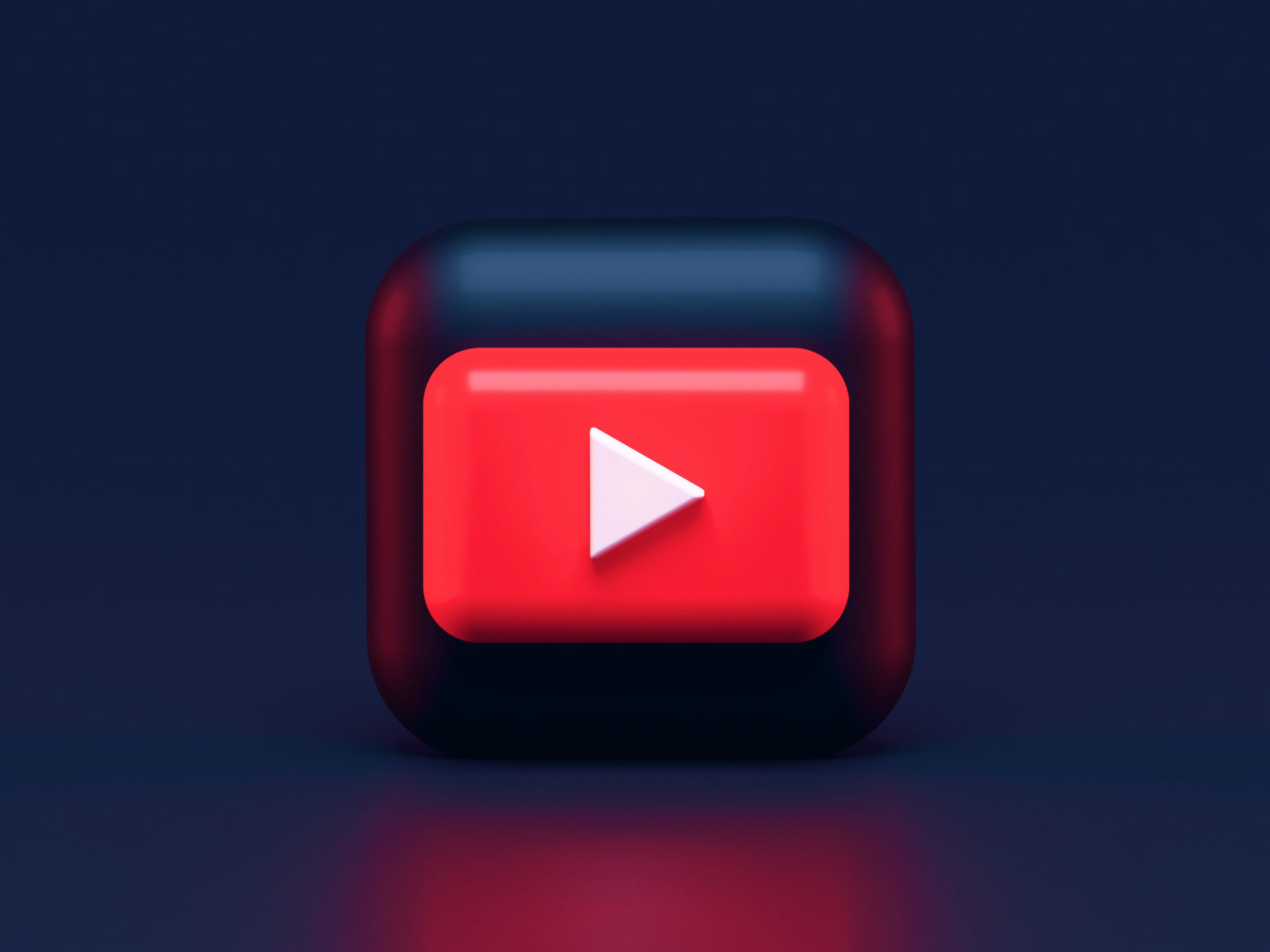 A 3D rendering of the youtube logo, in an ominous dark background with a red reflection in the foreground