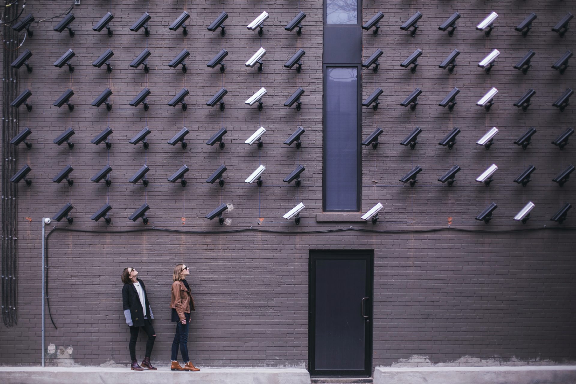 security cameras pointed at people, illustrating marketing data privacy